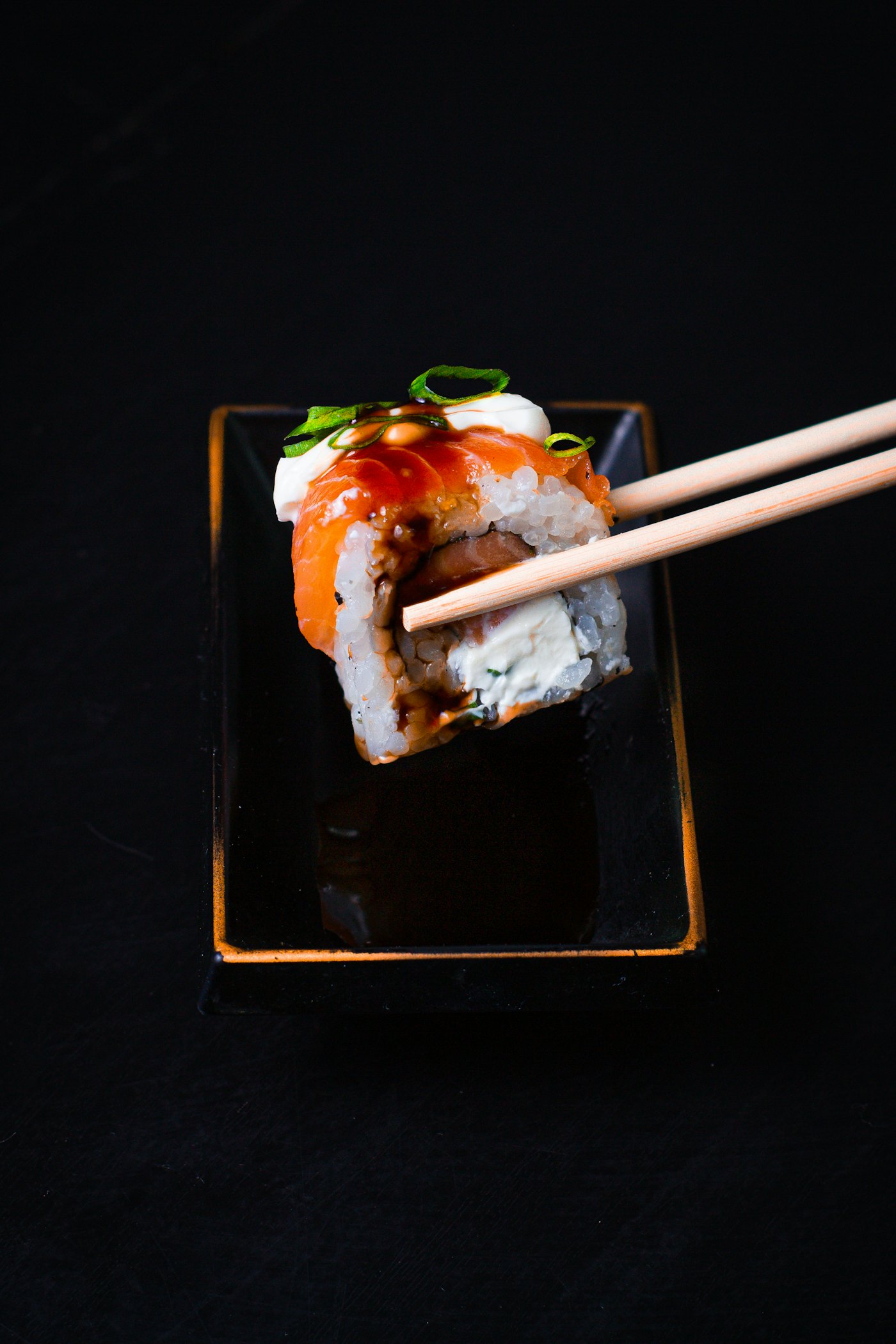 Sushi held with chopsticks