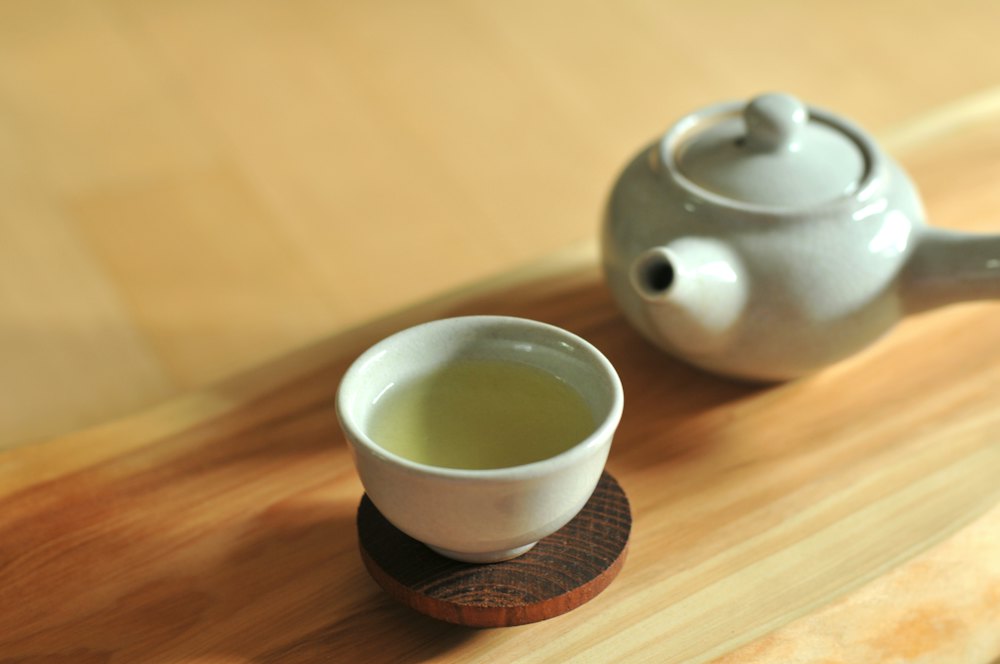 Japanese teapot and cup of green tea