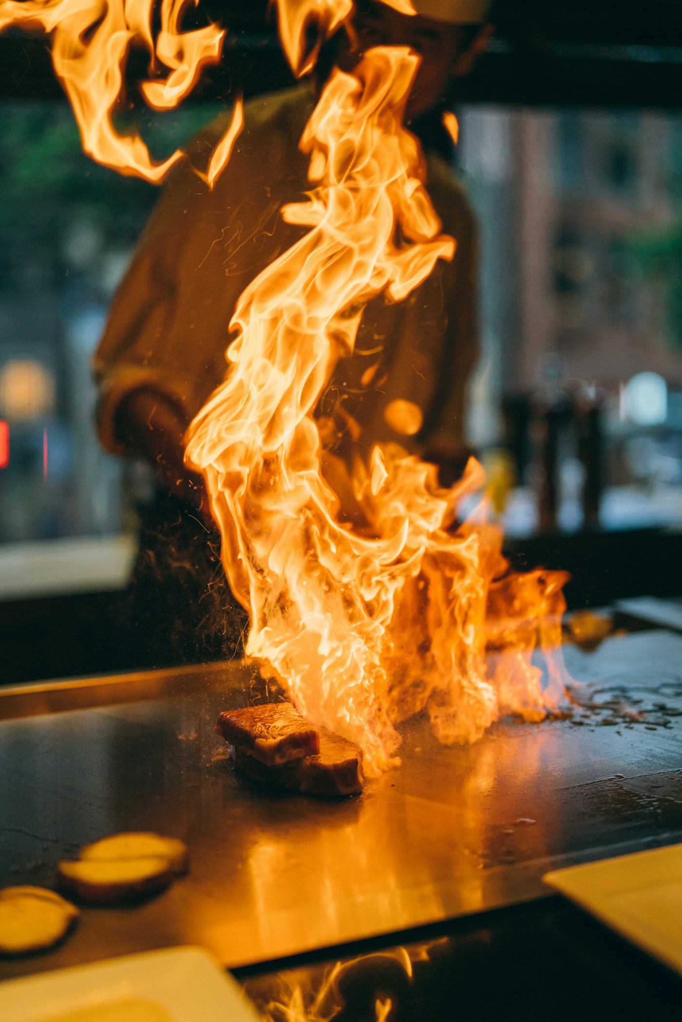 Flames rising from a teppanyaki grill