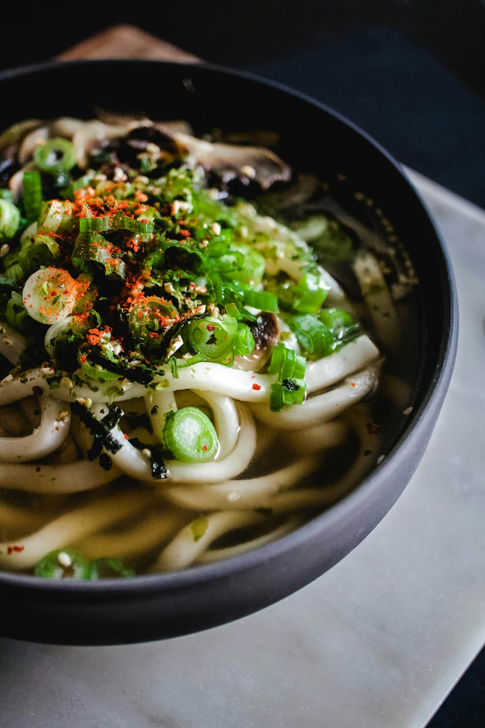 Bowl of udon noodle soup with green onions